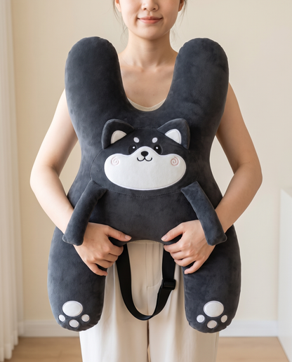 An adult holding Kudlee against her chest to show its real size, 22 by 16.5 inches
