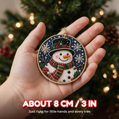 Finished snowman ornament in a child's hand, about 8 cm across